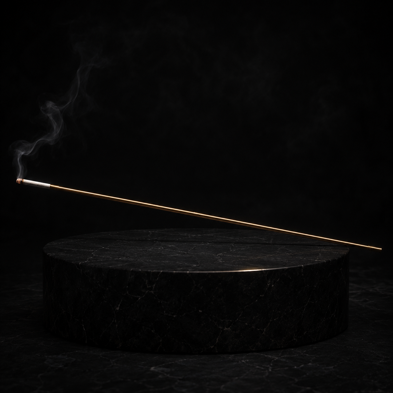 An exceptionally long gold cigarette holder above a black stone plinth